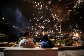Iranians watch fireworks during the Wednesday Fire feast, or Chaharshanbe Suri, held annually on the last Wednesday eve before the Spring holiday of Nowruz, in Tehran, on March 18, 2025. 