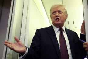 US President Donald Trump speaks to reporters aboard Air Force One on a flight back to Washington March 15, 2026.