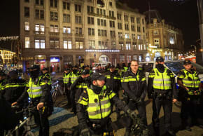 Police arrest individuals who allegedly threw a red substance at an Israeli flag and red smoke bombs in the middle of a demonstration, on December 17, 2025 in Amsterdam, Netherlands.