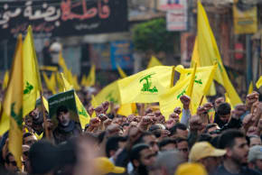 Mourners wave Hezbollah flags during the funeral of top Hezbollah chief Haytham Ali Tabatabai and other members killed in an Israeli strike in Beirut's southern suburbs on November 24, 2025.