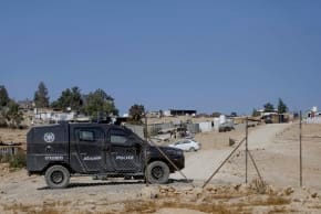 Israeli security forces guard Israeli settlers as they graze their livestock near the village of Umm al-Khair in Masafer Yatta, south of Hebron, on November 9, 2025. 