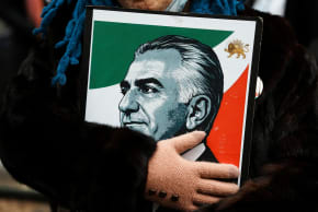 A protestor holds an image of Iranian Crown Prince Reza Pahlavi during a demonstration against the Iranian government, in New York City, March 15, 2026; illustrative.