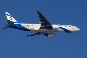 An Israeli El Al Boeing 777 aircraft flies over Tel Aviv during its landing approach to Ben Gurion Airport on March 16, 2026.