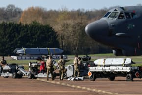 Members of a ground crew work to load cruise missiles into a U.S. Air Force Boeing B-52 Stratofortress at RAF Fairford airbase, used by United States Air Force (USAF) personnel, amid the U.S.–Israeli conflict with Iran, in Fairford, Gloucestershire, Britain, March 14, 2026.
