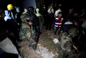 Palestinian security forces gather at the scene where Palestinian women were killed in an Iranian missile attack near Hebron in the West Bank March 18, 2026. 