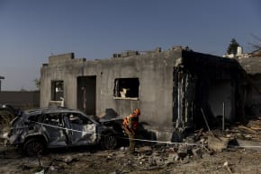  An emergency responder inspects a house that was destroyed by an Iranian ballistic missile strike on March 13, 2026 in Israel.