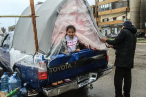 A displaced girl sits in the back of a pick-up truck in Lebanon’s southern city of Sidon on March 15. Lebanon is working to form a delegation to negotiate with Israel in a bid to stop the war with Hezbollah. 
