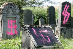 GRAVES DESECRATED by vandals with Nazi swastikas and antisemitic slogans are seen in the Jewish cemetery of Weyhers, Germany, near the city of Ebersburg, Aug. 2005.