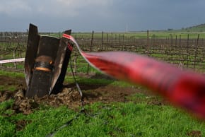 A fragment of a missile fired from Iran toward Israel, intercepted by Israeli air defense systems, seen lodged in the ground in the Golan Heights, March 19, 2026.