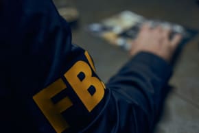 Illustrative image showing a close up on an FBI agent in uniform.