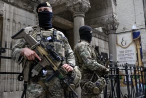Belgian military personnel armed with FN SCAR assault rifles stand guard outside a synagogue in central Antwerp as part of Belgium's reinforced security measures established at Jewish schools and synagogues, on March 23, 2026.
