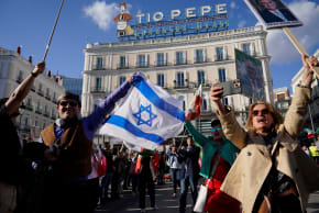 Members of the Iranian diaspora hold an Israeli flag during a protest in Puerta del Sol square in support of the Iranian people, following strikes by the U.S. and Israel against Iran, in Madrid, Spain, February 28, 2026.