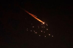 Rocket trails are seen in the sky amid a fresh barrage of Iranian missile attacks above the Israeli coastal city of Netanya on March 27, 2026.