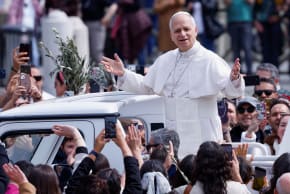 Pope Leo XIV gestures as he leaves after Palm Sunday Mass in Saint Peter's Square at the Vatican, March 29, 2026.