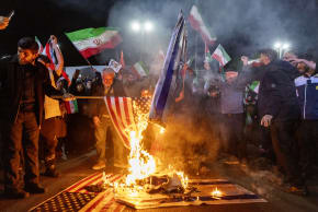 Iranians set fire to flags of the United States and Israel as they gather to commemorate those killed from the Dena naval vessel, in Tehran, earlier this month.