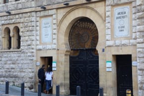 People stand at the main gate entrance of the American University of Beirut (AUB), in Beirut, Lebanon, January 21, 2021.