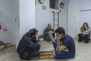 People take cover in a bomb shelter from incoming missiles fired from Iran in Tel Aviv, March 16, 2026.