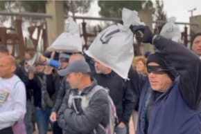 PROTESTERS GATHER outside the Knesset against the approved 2026 budget.