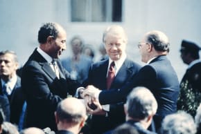 Then-US President Jimmy Carter (C) congratulates Egyptian president Anwar al-Sadat and prime minister Menachem Begin in three-way handshake on March 26, 1979 at the White House, after signing the historic US-sponsored peace treaty between Israel and Egypt. (photo credit: Consolidated News Pictures/AFP via getty Images)