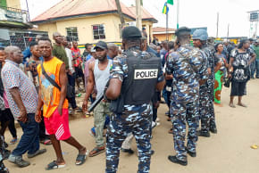 People gather as policemen arrive at the scene of an attack, the morning after gunmen killed multiple people in an overnight attack in Angwan Rukuba, Jos North, Plateau State, Nigeria March 30, 2026. 