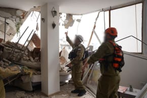 Home Front Command rescue teams seen at the scene of a collapsed building in Tel Aviv, April 1, 2026.