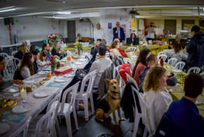 People celebrate the Passover Seder in an underground parking lot used as a public shelter during the ongoing war, April 1, 2026