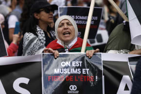 A protester holds a placard reading "we are Muslims and proud of it" during a rally against Islamophobia, in Paris on May 11, 2025. 