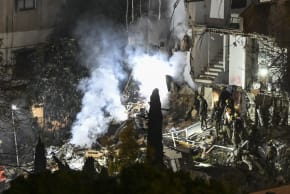 Israeli security and rescue forces at the scene where a missile fired from Iran toward Israel caused damage in Haifa, April 5, 2026.