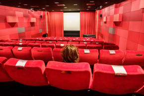 A woman sits alone in a Frankfurt, Germany, cinema in November 2021.