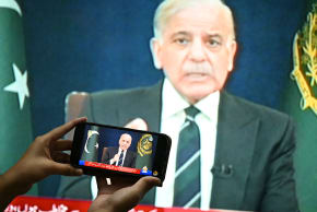 A resident listens on a mobile phone to an address to the nation by Pakistan's Prime Minister Shehbaz Sharif about the ongoing US-Israel conflict with Iran, in Islamabad on March 9, 2026.