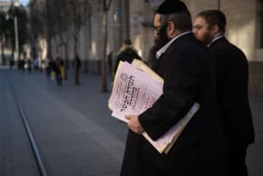 REPRESENTATIVES OF the Chief Rabbinate of Israel cross Jaffa Street in Jerusalem as they deliver a kosher certificate to a local restaurant.