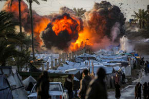 A FIREBALL erupts following an Israeli strike in central Gaza.