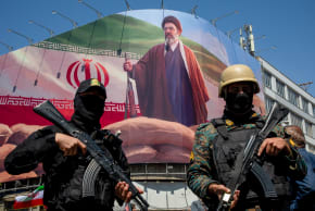 MEMBERS OF the Iranian security forces stand guard under a large portrait of Iran’s new Supreme Leader, Mojtaba Khamenei.