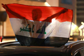 A boy holds an Iraqi flag near the Iranian embassy during a gathering following the announcement of a ceasefire between Iran and the United States, in Baghdad, Iraq, April 8, 2026. 