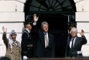 PLO chairman Yasser Arafat (L) waves with prime minister Yitzhak Rabin (R) and US president Bill Clinton after the signing of the Israeli-PLO peace accord, at the White House in Washington, in 1993. Israel was forced into Oslo to reduce international isolation, and it backfired, the author notes.