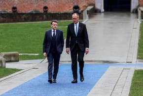 Germany's Chancellor Friedrich Merz and France’s President Emmanuel Macron walk at Alden Biesen castle, on the day of an informal European Union leaders retreat, Belgium, February 12, 2026.