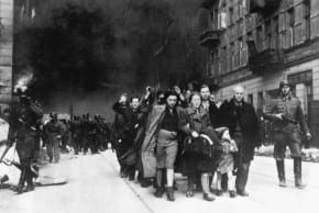 CAPTURED JEWS are led by German troops to the assembly point for deportation. Photo taken at Nowolipie Street, near intersection with Smocza Street.
