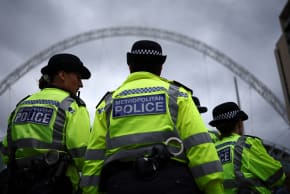 Metropolitan Police officers stand on duty as fans of US mega-star Taylor Swift, so-called "Swifties", as arrive at Wembley Stadium in London on August 15, 2024, ahead of the first of five concerts she is playing at the stadium.