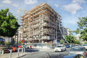 Rishon LeZion, Israel-June 10, 2017: Scaffolding around 4-storey house is located at 35 Katznelson Street. The building is being renewed in accordance with Tama 38 program. 