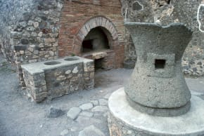 File photo: First century bakery in the Roman town of Pompeii, showing corn-mill, oven, and food counter, January 1, 1900.