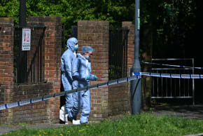 Police forensic officers work inside a cordon set up near to Kenton United Synagogue in Harrow, north-west London on April 19, 2026, the scene of an arson attack overnight.