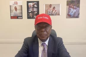LEO TERRELL in his Washington office wearing his Hadar Goldin hat, with hostage pictures in the background. Lt. Goldin died in a 2014 Hamas ambush in Gaza, with his body finally returned to be laid to rest in Israel this past Nov. (photo credit: US Department of Justice)