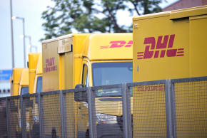  DHL delivery trucks parked outside a delivery center on August 26, 2025 in Berlin, Germany