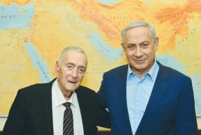 Late Israeli intelligence official Uri Lubrani standing next to Prime Minister Benjamin Netanyahu, in 2015. 