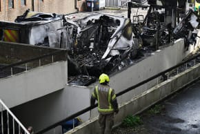 The burnt wreckage of Hatzalah ambulances as fire services continue to monitor the scene after they were set on fire overnight next to Machzike Hadath Synagogue, on March 23, 2026 in the Golders Green area of London, England.