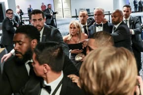 Security officials evacuate U.S. Health and Human Services (HHS) Secretary Robert F. Kennedy Jr. and his wife, Cheryl Hines, as a shooter opens fire during the annual White House Correspondents' Association dinner in Washington, D.C., U.S., April 25, 2026.