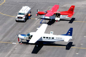A Cessna 208B Grand Caravan (foreground); illustrative.