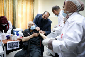 Palestinian medical workers receive Pfizer-BioNTecha vaccine against the Coronavirus at the Palestinian Medical center in the West Bank city of Dura on March 21, 2021.