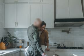 A FLEETING moment of calm: Shiri and her husband share a quiet exchange in the kitchen with their child, one of the ‘little things’ that hold a family together between deployments.