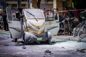 Security and rescue forces at the scene where an electric vehicle caught fire from its battery in Tel Aviv, July 29, 2024.